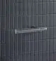 Chromfarbener Halter für Toilettenpapierrollen an einer Wand mit rechteckigen, schwarzen Fliesen. Ideal Standard Produkt, funktional gestaltet.